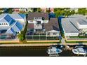 Aerial view of house near the water with a boat and a screened patio at 615 Mirabay Blvd, Apollo Beach, FL 33572