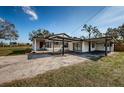 This single-story home features a connected carport and cozy covered porch at 6254 Pershing Ne St, St Petersburg, FL 33702