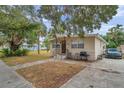 Tan block house with brown door, small front yard, and driveway at 652 13Th S Ave, St Petersburg, FL 33701