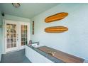 Front entry with double doors, tile flooring, and surfboard decor at 657 Garland Cir, Indian Rocks Beach, FL 33785