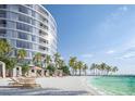 Relaxing beachfront setting with lounge chairs and tropical landscaping at 805 S Gulfview Blvd # 607A, Clearwater, FL 33767