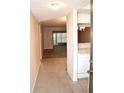 Bright entryway with tile flooring and view into living area and kitchen at 946 Virginia St # 102, Dunedin, FL 34698
