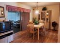 Dining area with table, chairs, and access to a sunroom at 1040 Bowsprit Ln # 1306, Holiday, FL 34691