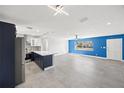 Open concept living area with blue accent wall and tile flooring at 1204 Dartmouth Dr, Bradenton, FL 34207