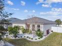 Single-story home with landscaped yard and two-car garage at 12332 Prairie Valley Ln, Riverview, FL 33579