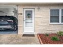 Front door of a light-colored, single-story home with carport at 12400 Park Blvd # 206, Seminole, FL 33772
