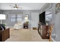 Living room features gray walls, carpeted floors, and a ceiling fan at 12400 Park Blvd # 206, Seminole, FL 33772