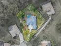 Bird's-eye view of a house with pool, located in a residential neighborhood at 12632 Oak Hollow Ct, Dade City, FL 33525