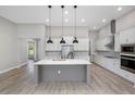 Modern kitchen with white cabinets, quartz island, and stainless steel appliances at 13458 Haflinger Way, Hudson, FL 34667
