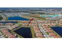 Aerial view of the community with scenic ponds and community pool and new homes at 17014 Clear Cork Dr, Wimauma, FL 33598