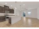 Modern kitchen with dark cabinetry and quartz countertops at 18909 Ulmus St, Lutz, FL 33558