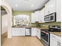 Modern kitchen with granite counters and stainless steel appliances at 31211 Gossamer Way, Wesley Chapel, FL 33543
