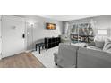 Living room features gray sectional sofa and access to balcony at 3245 Beneva Rd # 201, Sarasota, FL 34232
