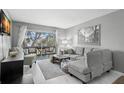 Spacious living room with sectional sofa and access to balcony at 3245 Beneva Rd # 201, Sarasota, FL 34232