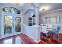 Bright dining area features hardwood floors, large windows and glass dining table at 335 Palmdale Dr, Oldsmar, FL 34677