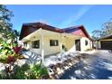 Front view of a ranch-style home with covered porch at 4409 Ann Arbor Dr, Tampa, FL 33610