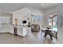 Open-concept kitchen and living area with modern appliances at 5206 Whispering Leaf Trl, Valrico, FL 33596