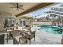 Covered patio area overlooking a refreshing pool at 5206 Whispering Leaf Trl, Valrico, FL 33596