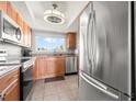 Light filled kitchen featuring stainless steel appliances and granite countertops at 90 S Highland Ave # 1306, Tarpon Springs, FL 34689