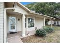 Inviting front porch with a white door and large window at 10504 Tapestry Dr, Port Richey, FL 34668