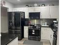 Updated kitchen with stainless steel appliances and granite counters at 1202 W Camellia Dr, Brandon, FL 33510