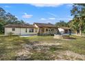 House exterior showcasing a stone facade and a circular pool at 18801 Orange Hill Dr, Hudson, FL 34667