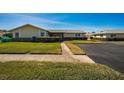Tan single story home with paved driveway and green lawn at 2820 Highlands Blvd # A, Palm Harbor, FL 34684