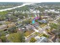 Aerial view of a residential home in a neighborhood with lush greenery and access to water at 3310 Briarwood Ln, Safety Harbor, FL 34695