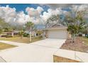 Charming single-story home featuring well-manicured lawn, stone accents, and attached two-car garage at 3310 Briarwood Ln, Safety Harbor, FL 34695