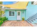 Welcoming patio area with brick pavers and a white door at 604 Pennsylvania Ave, Crystal Beach, FL 34681