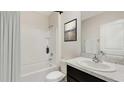 Clean bathroom with a bathtub, shower, and dark brown vanity at 6123 Distant Haze Pl, Palmetto, FL 34221