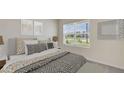 Cozy bedroom with a queen-size bed and neutral color scheme at 6123 Distant Haze Pl, Palmetto, FL 34221