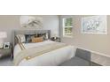Bright bedroom with a queen bed, neutral decor, and natural light at 6123 Distant Haze Pl, Palmetto, FL 34221