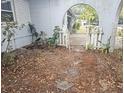 Small front yard with mature trees and a white picket gate at 6692 17Th N Way, St Petersburg, FL 33702