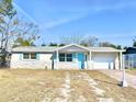 Nice curb appeal! One-story home with light-colored brick exterior, light blue accents, and a brick driveway at 7711 Rottingham Rd, Port Richey, FL 34668