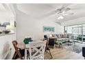 Cozy condo living room featuring a ceiling fan, comfy seating, and bright natural light at 9945 47Th N Ave # 206, St Petersburg, FL 33708