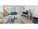 Comfortable living room featuring stylish furnishings, neutral colors, and access to a bright sunroom at 9945 47Th N Ave # 206, St Petersburg, FL 33708