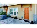 Inviting front entrance of townhome with orange door and landscaping at 1275 Drew St, Clearwater, FL 33755