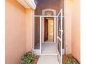Front entrance with screen and solid doors leading inside at 1330 Misty Greens Dr, Sun City Center, FL 33573