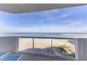 Oceanfront balcony with glass railing and seating at 1350 Gulf Blvd # 604, Clearwater, FL 33767