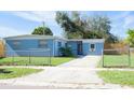 Newly painted light blue home with a spacious yard and driveway at 2009 Windsor Way, Tampa, FL 33619