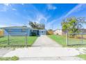 Newly painted light blue home with a spacious yard and driveway at 2009 Windsor Way, Tampa, FL 33619