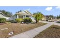 Front yard view of a charming house with a well-maintained lawn and landscaping at 24745 Portofino Dr, Lutz, FL 33559