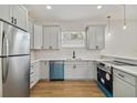 Modern kitchen with gray cabinets, quartz countertops, and teal dishwasher at 2515 N Howard Ave, Tampa, FL 33607