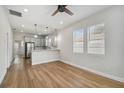 Open concept living room with hardwood floors and modern kitchen at 2515 N Howard Ave, Tampa, FL 33607