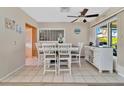 Bright dining area with a white table and chairs, and built-in storage at 2533 Duncan Dr, Belleair Bluffs, FL 33770