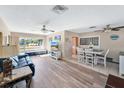 Bright living room featuring hardwood floors and a dining area at 2533 Duncan Dr, Belleair Bluffs, FL 33770