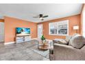 Cozy living room featuring tile floors, a ceiling fan, and a comfortable couch at 2619 Miriam S St, Gulfport, FL 33711