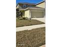 Two-story townhome with attached garage and well-manicured lawn at 2933 Jacob Crossing Ln, Holiday, FL 34691