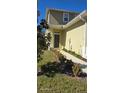 Townhome entry with walkway, landscaping, and dark brown door at 2933 Jacob Crossing Ln, Holiday, FL 34691